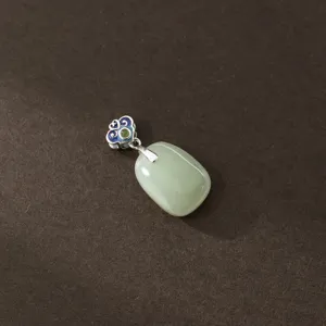 Close-up detail of the oval celadon jade pendant showing fine S925 silver cloud craft.