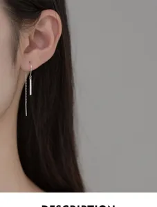 Gros plan détaillé de boucles d'oreilles pendantes minimalistes en argent s925 avec strass.