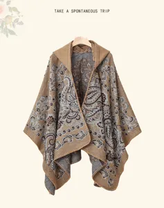 Women's winter hooded knitted shawl cape with vintage paisley pattern, warm and versatile outerwear.