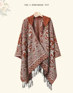 Detailed view of the ethnic style hooded cape, showing intricate pattern and tassel hem.