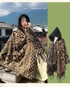 Detailed view of the ethnic hooded knitted poncho shawl featuring intricate retro patterns and fringe.
