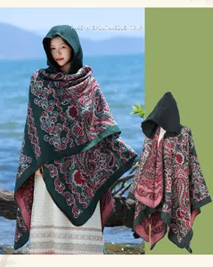 Detailed view of women's hooded printed winter cape shawl, stylish cozy ethnic fringe design.