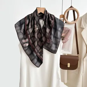 Close-up detail of luxury vintage plaid silk scarf, elegant draped pattern and soft texture.