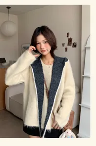 Detailed close-up view of women cozy hooded fuzzy knit cardigan in beige and dark grey.