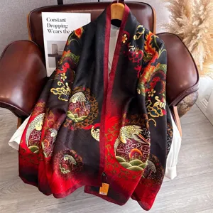 Detailed view of a luxurious black and red gradient silk scarf with exquisite oriental print.