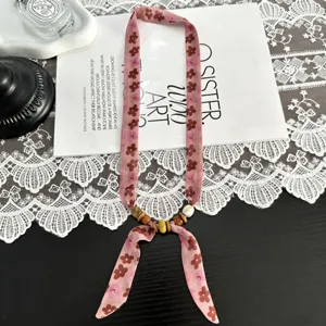 Vintage floral ribbon necklace with wooden beads, elegant tie-neck accessory for women.