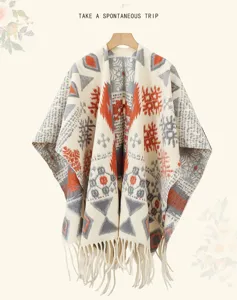 Ethnic geometric pattern thick warm women shawl poncho with stylish tassel hem detail.