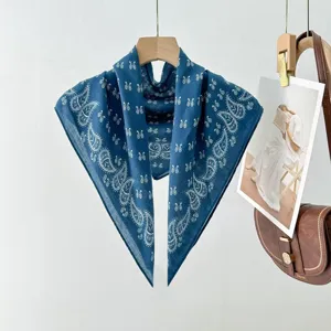 Detailed view of a vintage blue paisley cotton scarf, elegant neckerchief for stylish outfits.