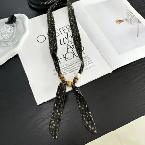 Vintage beaded silk scarf necklace for women, stylish black and gold accessory sweater chain.