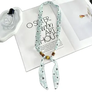 Retro floral silk scarf necklace with wooden beads, stylish vintage boho neck accessory.