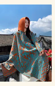 Detail view of ethnic style hooded poncho, orange and blue contrast knit cloak shawl.