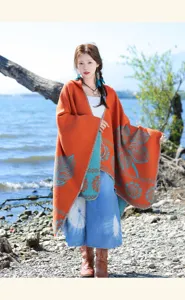 Ethnic style long imitation cashmere poncho detail, vibrant orange cloak with blue leaf patterns.