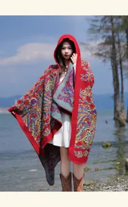 Detail view of a stylish red ethnic hooded cape shawl, perfect for warm autumn and winter wear.