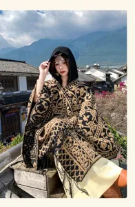 Ethnic style hooded cape detail view, exquisite geometric pattern, elegant fringe design.