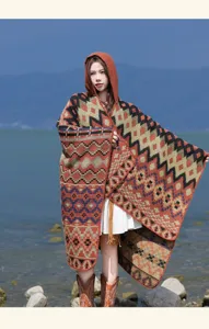 Detailed view of the boho hooded tassel poncho with multi-color geometric pattern cape shawl.