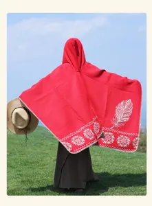 Red hooded cashmere-feel cloak with ethnic feather pattern, perfect for travel and outdoor wear.