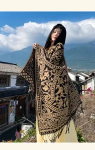 Ethnic style hooded cashmere-feel cloak with intricate gold patterns and fringe hem details.