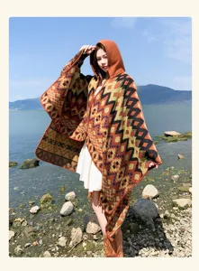 Detail view of bohemian geometric patterned hooded poncho, ideal for outdoor travel outfits.