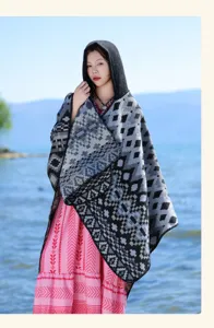 Bohemian hooded geometric knit shawl, cozy winter autumn cape, stylish ethnic travel outerwear.