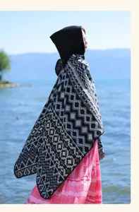Detailed showcase featuring the bohemian geometric hooded imitation cashmere shawl and cape design.