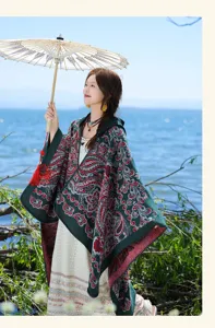Outdoor lifestyle detail shot of a vintage patterned warm knitted poncho shawl in green.