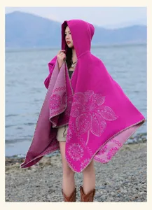 Detailed view of ethnic style hooded cashmere-feel cape shawl outdoors by the lake.