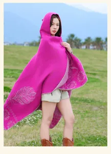 Ethnic style pink hooded cloak detail showcasing exquisite feather and geometric pattern design.