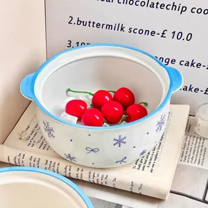 Cute ceramic soup bowl with blue handles and cute snowflake pattern for home kitchen use.