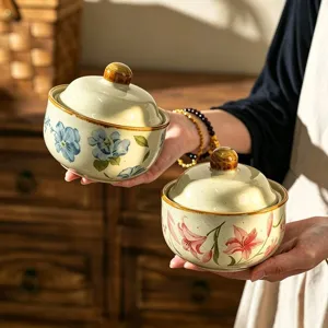 Close-up detail of Japanese ceramic stew pot with lid, floral painted design for home use soup.