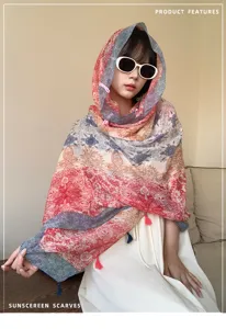 Close-up detail of ethnic style sunscreen scarf with vibrant floral print and tassels.