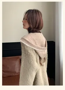 Detailed view of women plush hooded sweater, soft knit warm texture side silhouette.