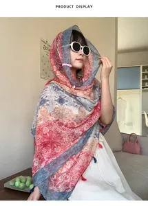 Close-up detail of ethnic style patterned scarf and delicate tassels for summer sun protection.