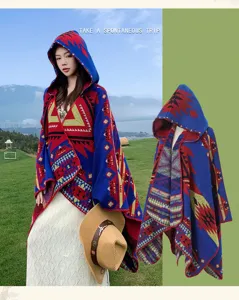 Detailed view of the ethnic knitted hooded cloak, showcasing unique geometric patterns and fringe.