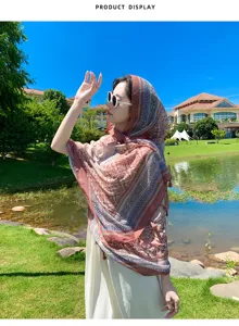 Outdoor scenic detail view of ethnic patterned women sun protection scarf and shawl style.