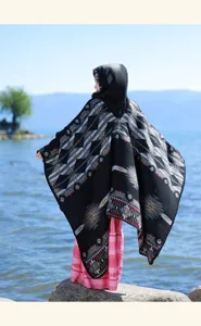 Detailed view of women ethnic knit hooded cape, showcasing vintage geometric patterns.