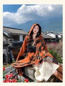 Ethnic style knitted hooded poncho cloak, vibrant geometric pattern winter outer wear detail.