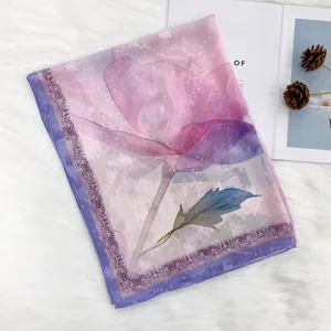 Detailed view of the pink floral printed silk scarf, soft sheer fabric with elegant floral motif.