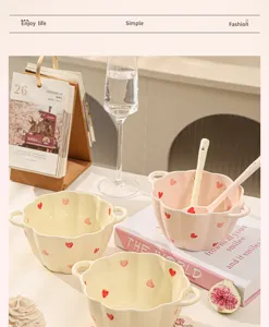 Ceramic bowl set detail view, cute heart pattern pumpkin shape with double handles.