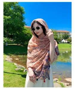 Detailed view of the ethnic style sun protection scarf with elegant floral prints and tassels.
