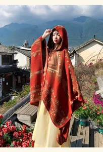 Outdoor detail view of ethnic style knitted hooded poncho cloak with geometric patterns.