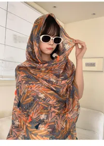 Detail shot of floral print summer shawl, lightweight ethnic style scarf for sun protection.