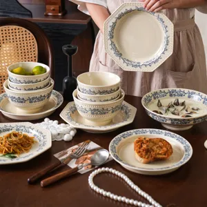 French vintage ceramic dinnerware set with blue floral bead pattern, tabletop display