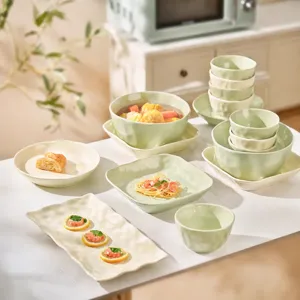 Cream style ceramic tableware set including rice bowls, soup bowls and plates for home use.