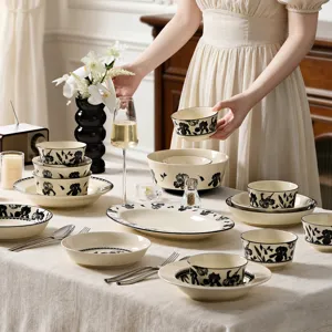 Luxury vintage ceramic bowl and plate set, elegant black floral dinnerware for home table use.