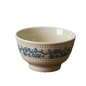 French vintage style ceramic rice bowl with elegant beaded rim and blue floral vine pattern.