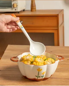Detailed view of ceramic soup bowl and ladle set with cute yellow flower pattern design.