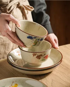 Detailed shot of Japanese underglaze ceramic bowl set with hand-painted floral art and retro glaze.