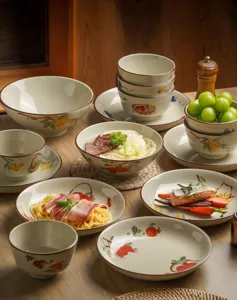 Japanese underglaze ceramic tableware set, detailed view of bowls and plates with fruit motifs.