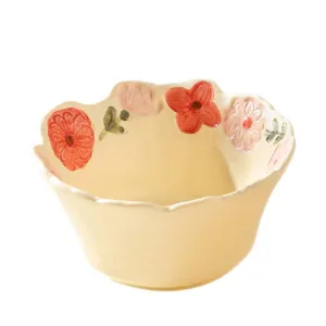 Cute ceramic noodle bowl with floral relief, cream yellow tableware for home kitchen use.