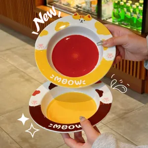 Cute cartoon ceramic dinner plate with cute cat and cow pattern, handheld main view display.